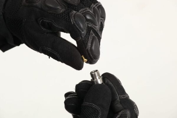 A pair of black gloves holding a gun.