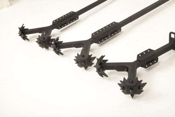 A set of black metal spikes on a white surface.