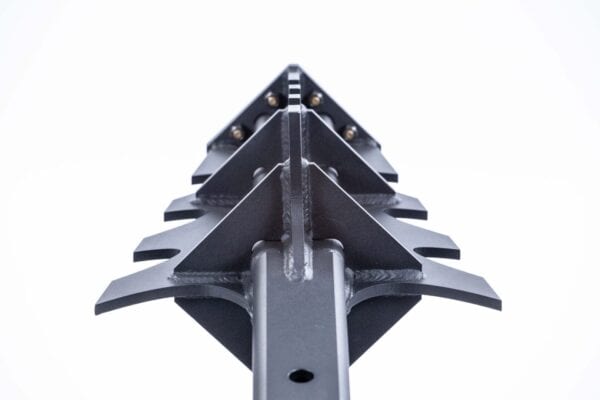 A close up of a metal spike on a white background.