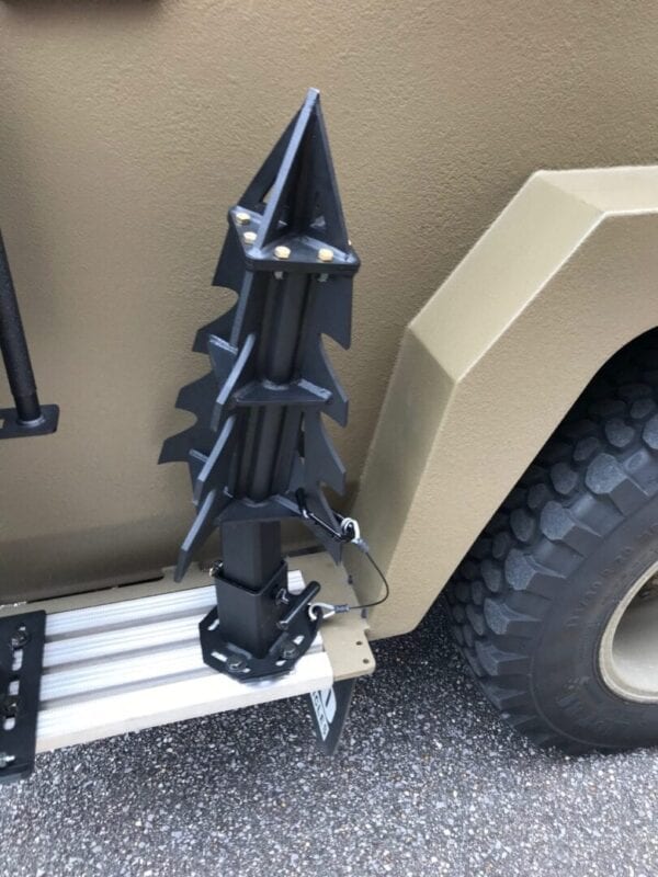 A military DRACO TRUCK MOUNT with a spike on the side of it.