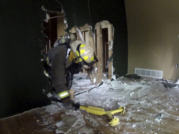 A firefighter in a room with a RIT-3 Tool.