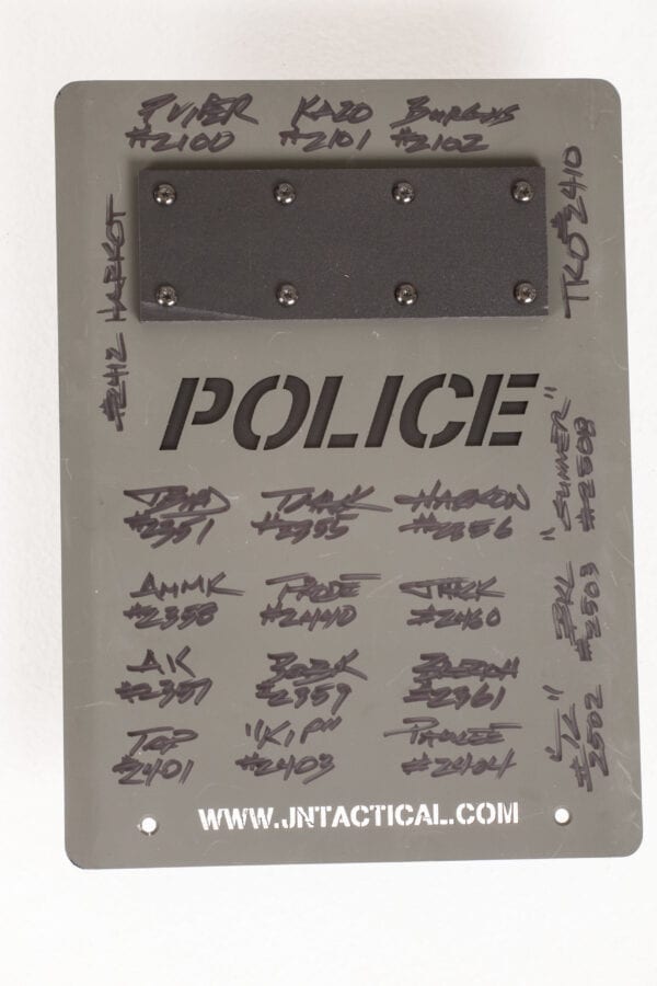 A SWAT Award - Tactical Shield plaque with a lot of writing on it.