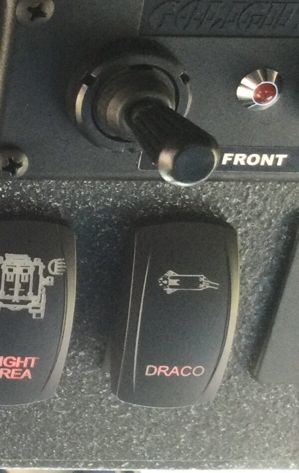 The control panel of a boat with DFS-10 - DRACO Wireless Electronic Firing System buttons on it.